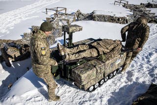 Soldiers demonstrate how the Tencore Unmanned Ground Vehicle (UGV) TerMIT is used for evacuation procedures